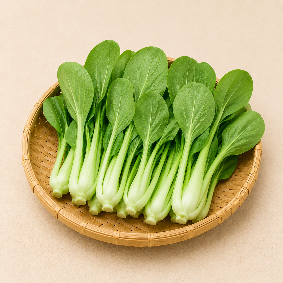 Baby bok choy in a round wicker basket, green leaves with pale stems